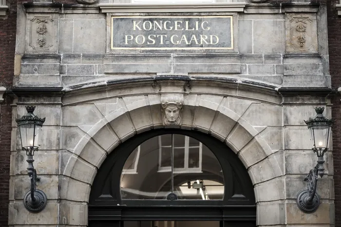 Framed Print : Detailed architecture of a historical postal station building with a central archway and ornamental lamps in Copenhagen Framed Print : Detailed architecture of a historical postal station building with a central archway and ornamental lamps in Copenhagen