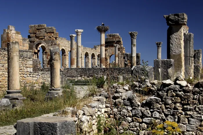 Framed Print : Detailed view of the basilica of Volubilis with well-preserved columns against a bright blue sky