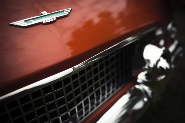 Framed Print : Detailed view of a red vintage Ford Thunderbird logo and grille with chrome elements in St