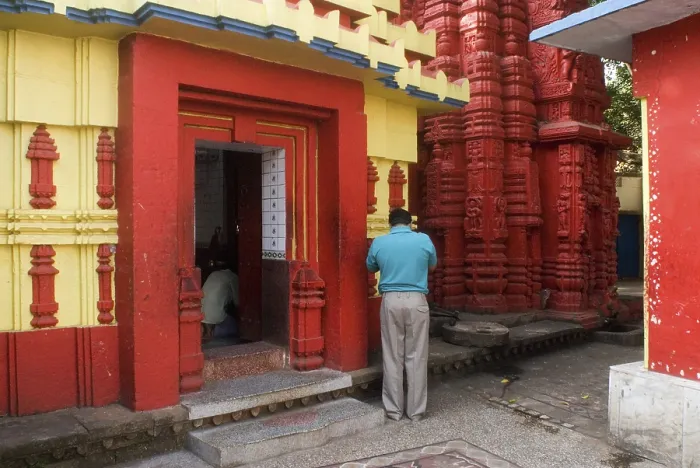 Framed Print : Devotee at 11th century Brahmeshwar temple dedicated to the lord Shiva considered prime example of Orissan architecture