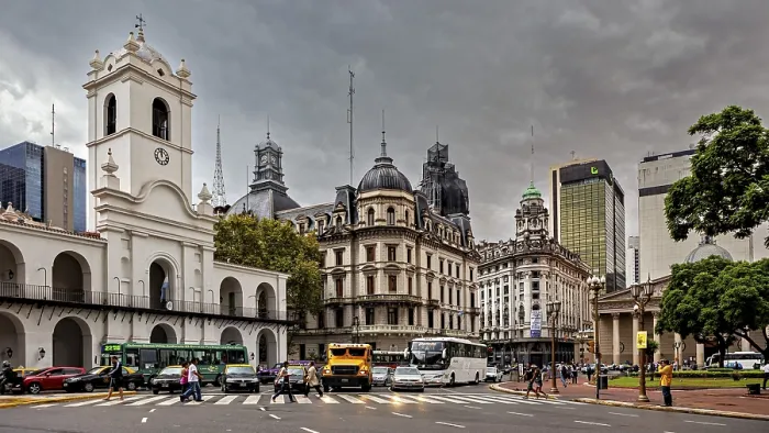 Framed Print : Different architectural styles meet under a cloudy sky in an urban space