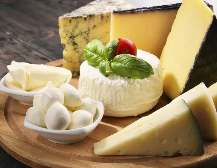 Framed Print : Different sorts of cheese on kitchen table Framed Print : Different sorts of cheese on kitchen table