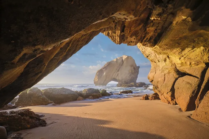 Framed Print : Discover the stunning Penedo do Guincho rock arch framed by a cave