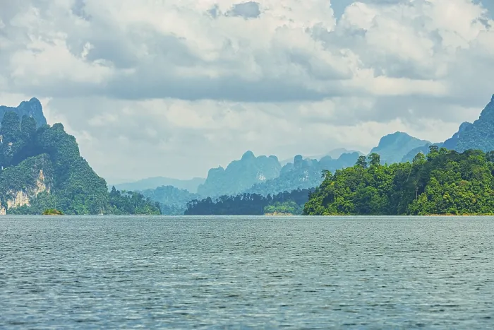 Framed Print : Distant mountains on a cloudy horizon overlook a vast lake