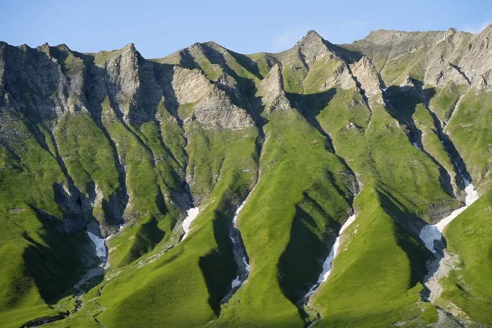 Framed Print : Distinctive rocky ridges with green vegetation under clear Framed Print : Distinctive rocky ridges with green vegetation under clear
