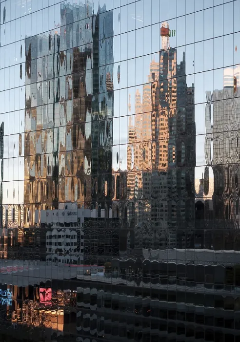 Framed Print : Distorted reflections of buildings on a glass facade in warm morning light in Toronto