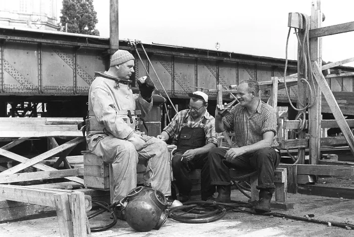 Framed Print : A diver in 1953, sitting in his diving suit and drinking coffee