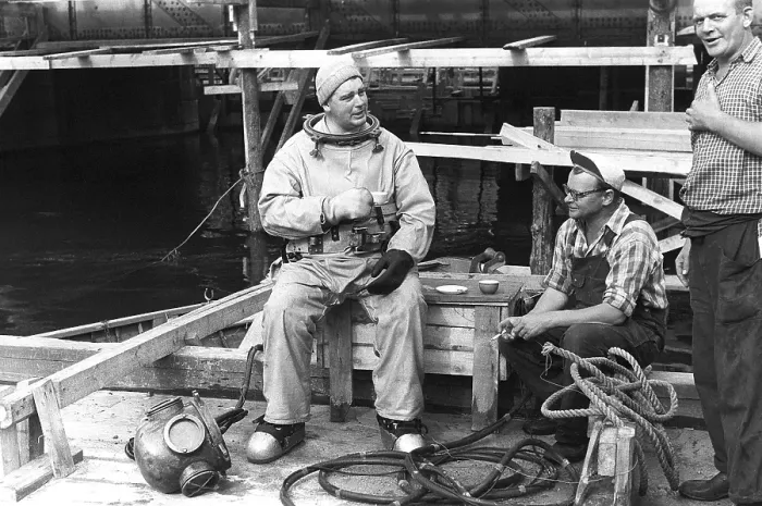 Framed Print : A diver in 1953, sitting in his diving suit and drinking coffee Framed Print : A diver in 1953, sitting in his diving suit and drinking coffee