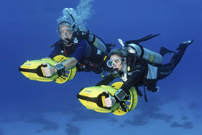 Framed Print : Divers with diver propulsion vehicles exploring a coral reef Framed Print : Divers with diver propulsion vehicles exploring a coral reef