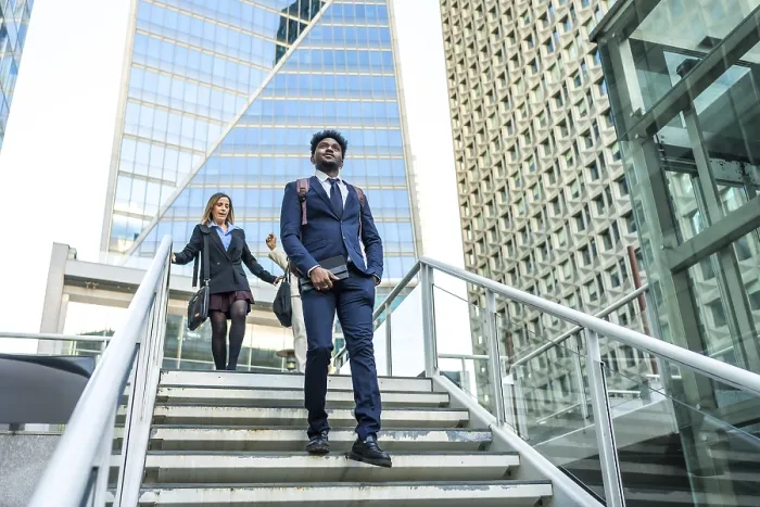 Framed Print : Diverse business people walking on stairs in a contemporary urban environment with tall