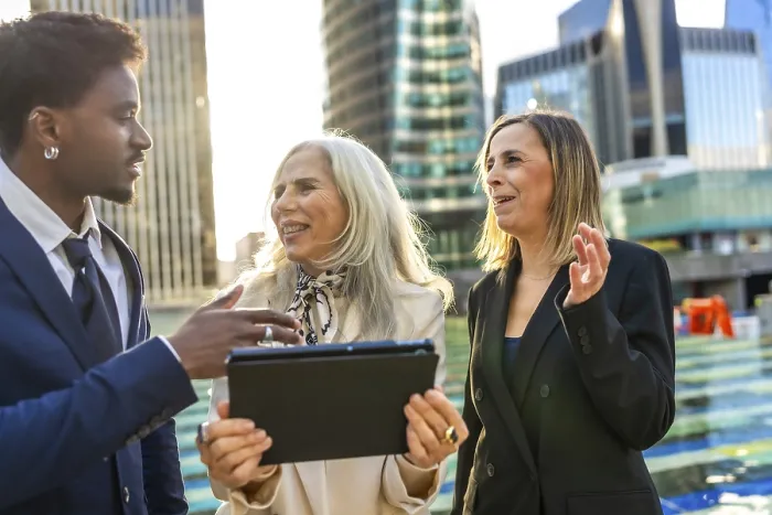 Framed Print : Diverse business team engaging in an informal outdoor meeting Framed Print : Diverse business team engaging in an informal outdoor meeting