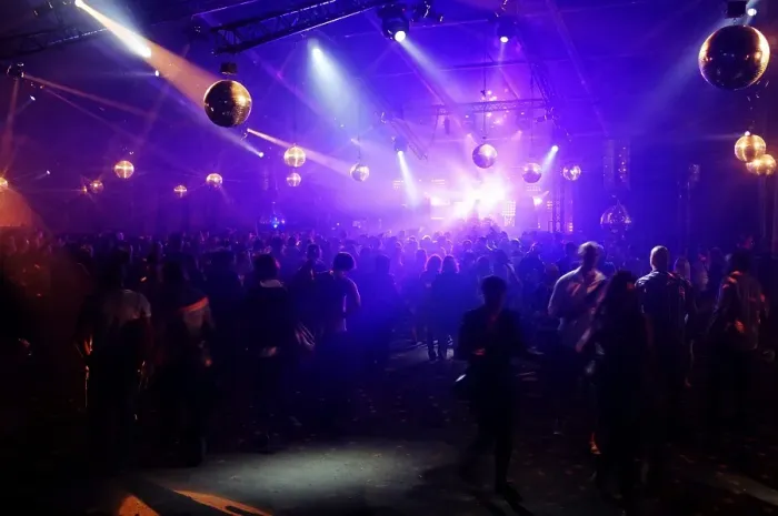 Framed Print : DJ entertaining a crowd in a party tent