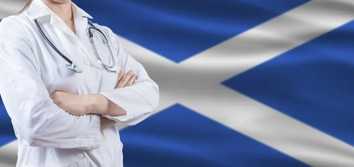 Framed Print : Doctor with crossed arms on Scottish flag Framed Print : Doctor with crossed arms on Scottish flag