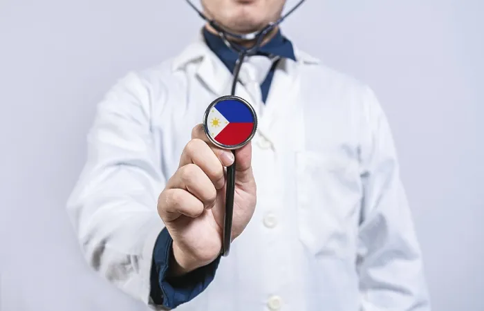 Framed Print : Doctor hands holding stethoscope with Philippines flag