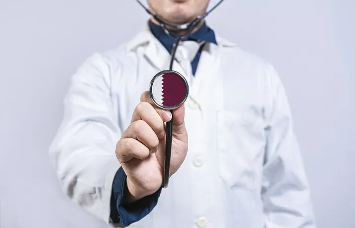 Framed Print : Doctor hands holding stethoscope with Qatar flag