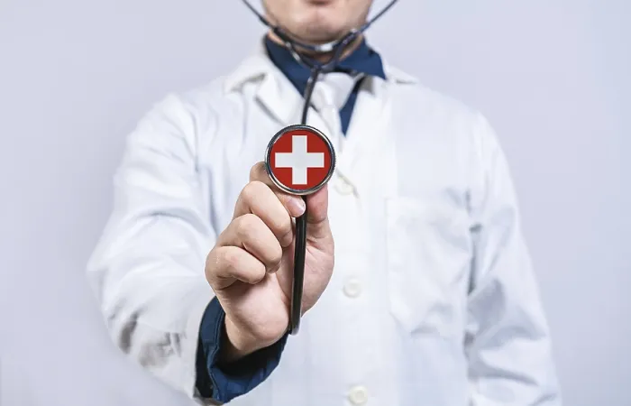Framed Print : Doctor hands holding stethoscope with Switzerland flag