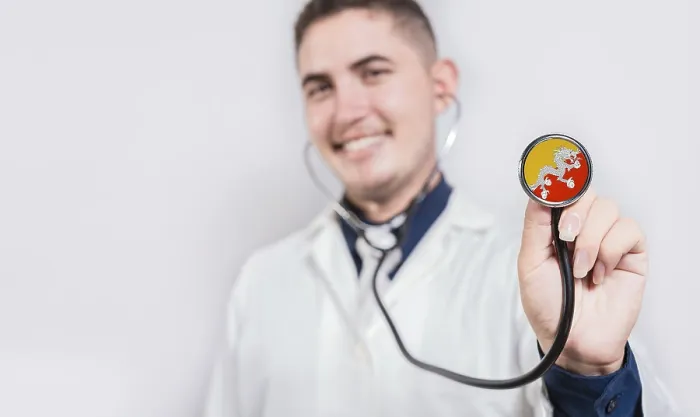 Framed Print : Doctor showing stethoscope with Bhutan flag