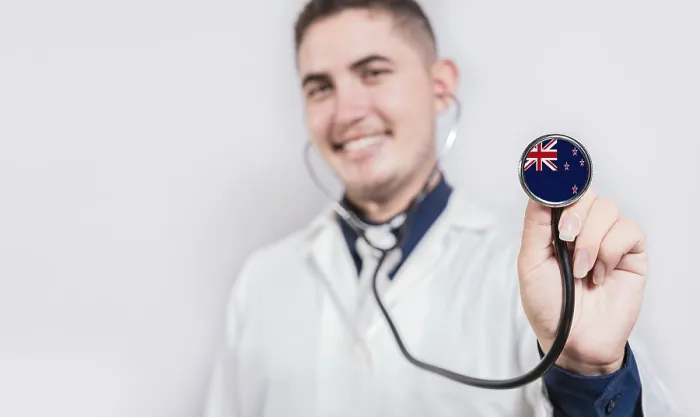 Framed Print : Doctor showing stethoscope with New Zealand flag
