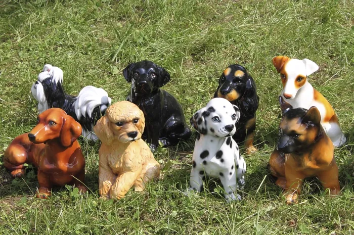 Framed Print : Dog breed statues on a grass background