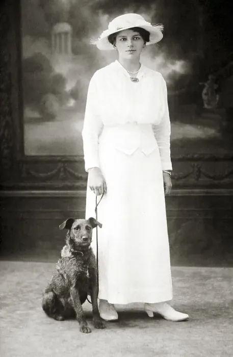 Framed Print : Dog next to woman in white dress