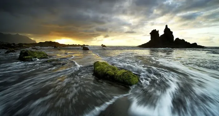 Framed Print : Dramatic cloud atmosphere with rock formation at sunset on the beach of Playa de Benijo
