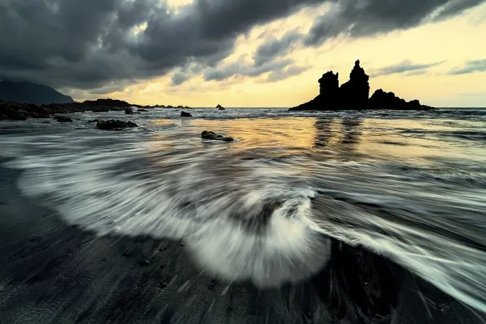 Framed Print : Dramatic cloud atmosphere with rock formation at sunset on the beach of Playa de Benijo