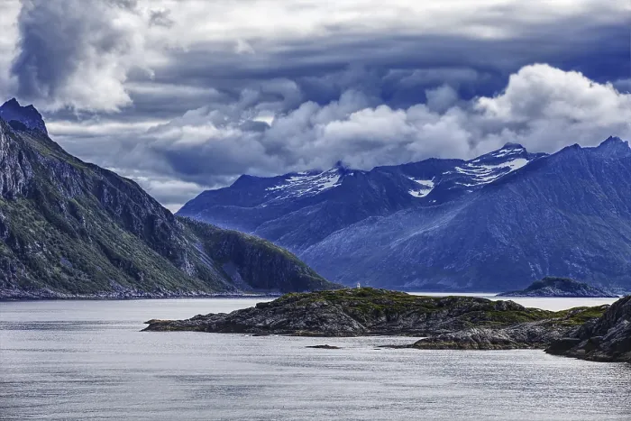 Framed Print : Dramatic fjord landscape with mountains and clouds under a stormy sky