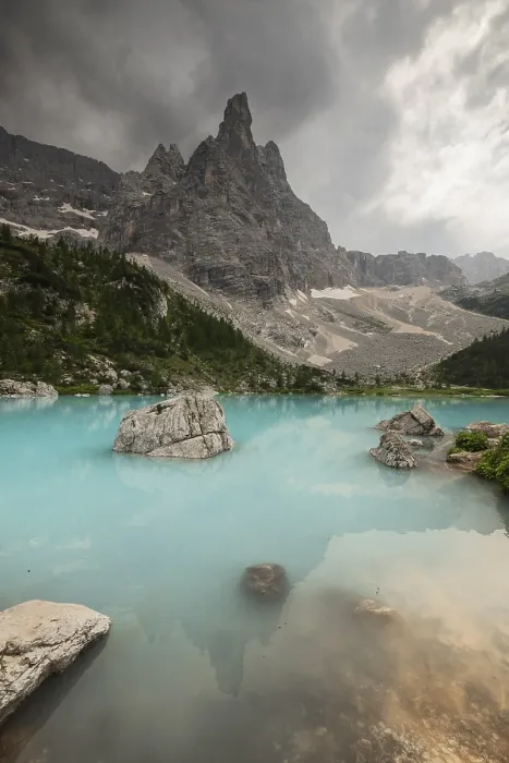 Framed Print : A dramatic mountain scene with a turquoise lake (Lago di Sorapis) and rocky formations under an overcast sky Framed Print : A dramatic mountain scene with a turquoise lake (Lago di Sorapis) and rocky formations under an overcast sky