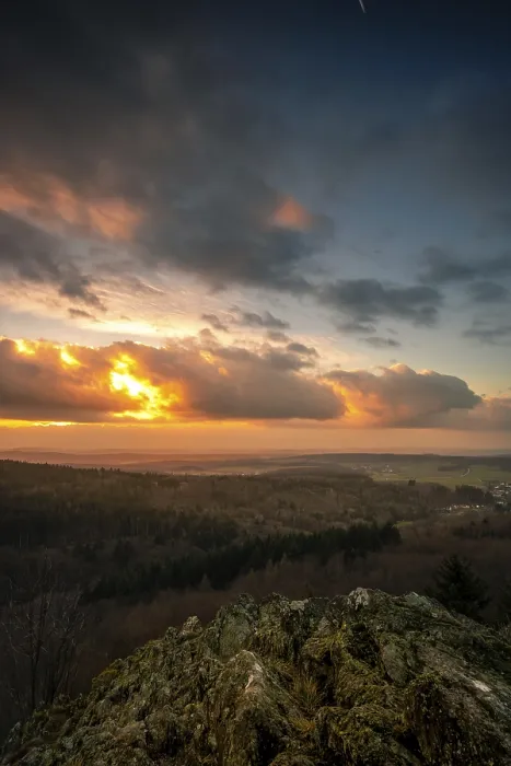 Framed Print : A Dramatic Sunset in the Evening with Clouds over a Valley in the Forest