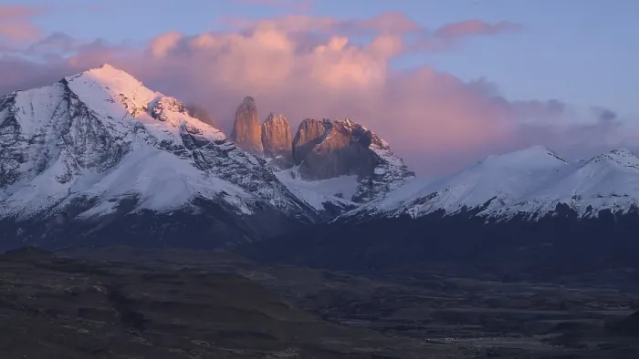 Framed Print : Dramatic sunset over snowy mountains with pink clouds and evening light