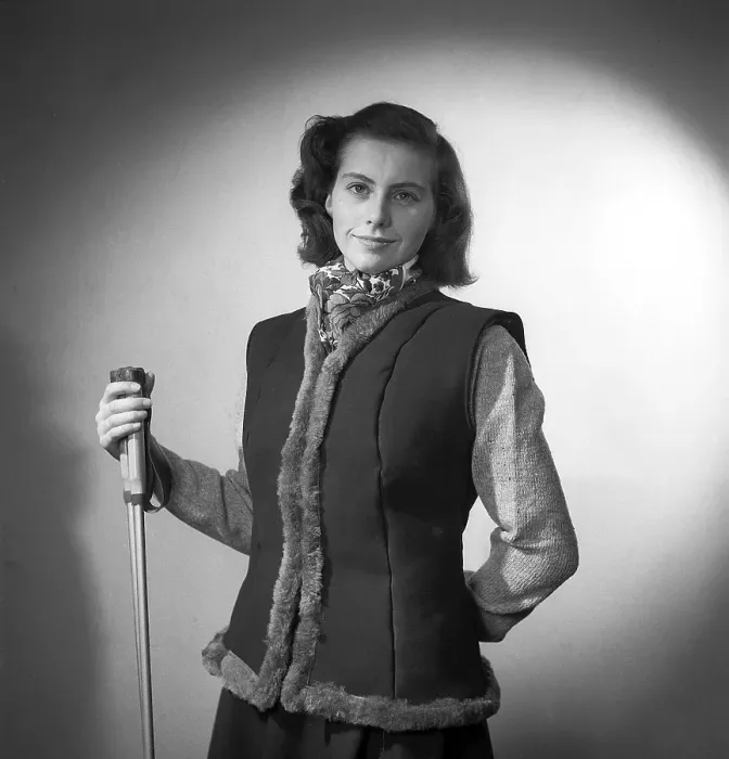 Framed Print : She is dressed in this year's fashion for outdoor and leisure use. A lined waistcoat with a long-sleeved knitted jumper underneath. She is holding a pair of ski poles to emphasise the outdoors Framed Print : She is dressed in this year's fashion for outdoor and leisure use. A lined waistcoat with a long-sleeved knitted jumper underneath. She is holding a pair of ski poles to emphasise the outdoors