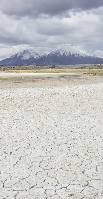 Framed Print : Dried up salt lake with the volcanos Parinacota