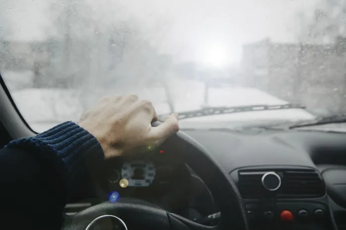 Framed Print : Driver view with hand on steering wheel in foggy conditions