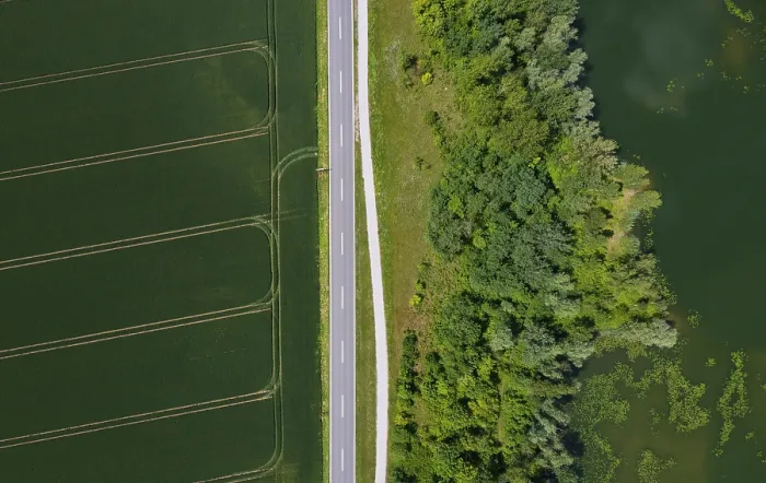 Framed Print : Drone image, country road between fields and pond