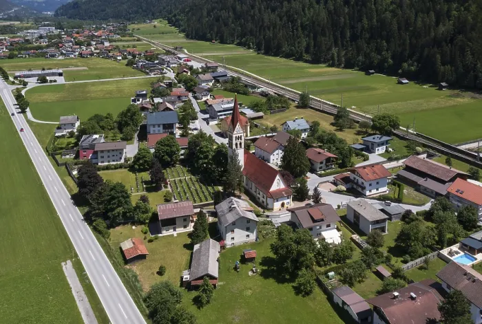 Framed Print : Drone shot, view of village with parish church Framed Print : Drone shot, view of village with parish church
