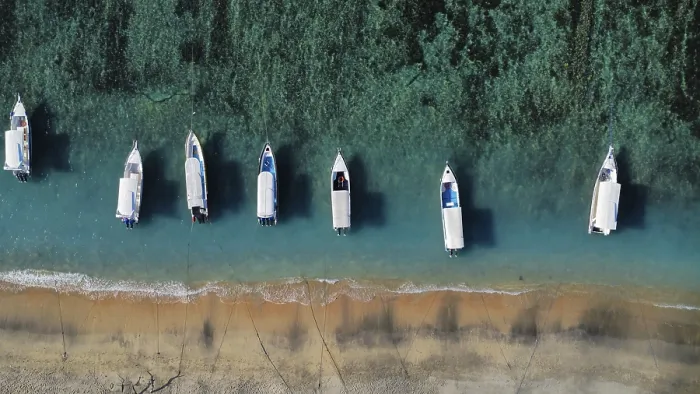 Framed Print : A drone view of an idyllic beach with moored boats in Indonesia