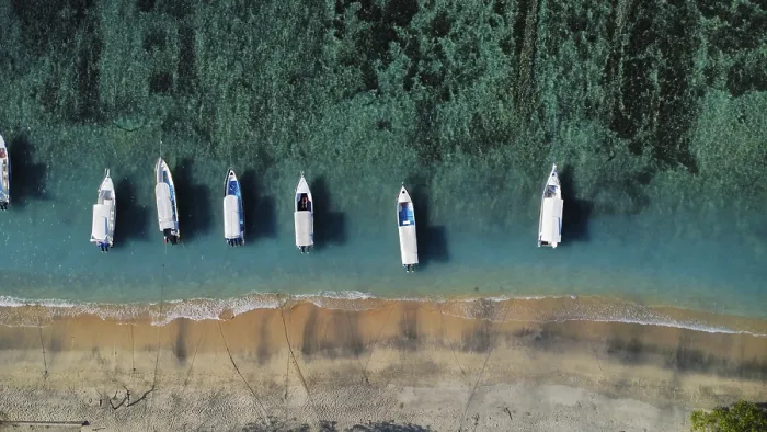 Framed Print : A drone view of an idyllic beach with moored boats in Indonesia
