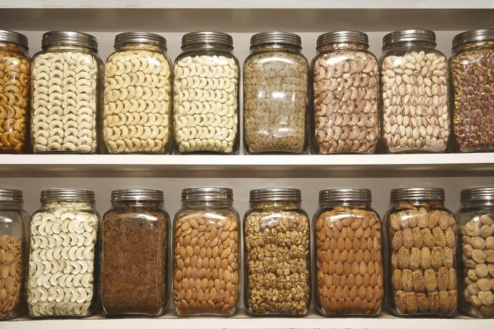 Framed Print : Dry fruits kept in different glass jars on selves in shop Framed Print : Dry fruits kept in different glass jars on selves in shop