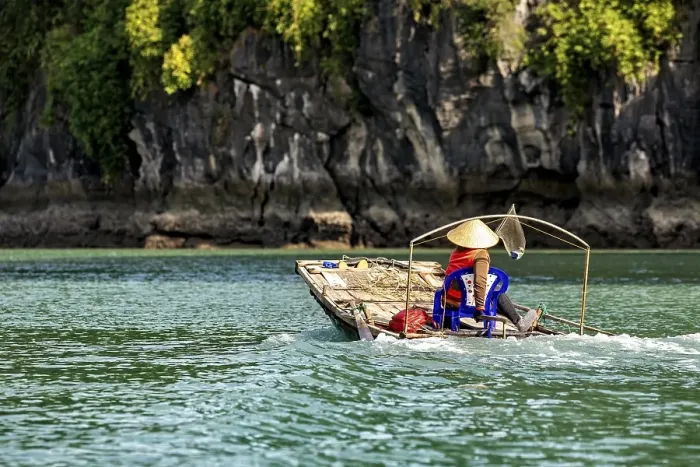 Framed Print : A dugout canoe with a seated person glides silently through clear