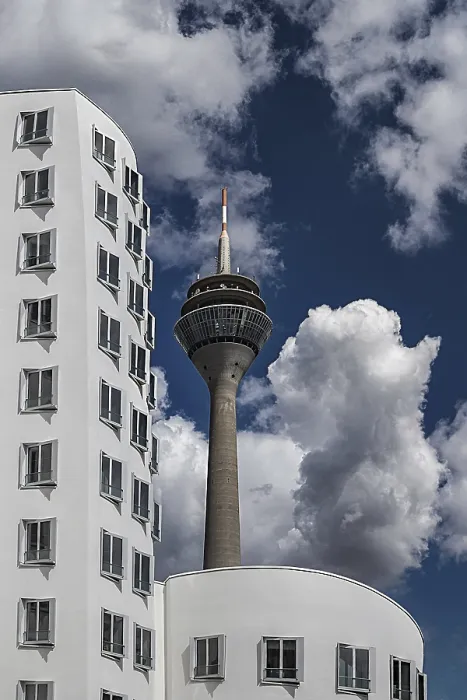 Framed Print : The Dusseldorf Rhine Tower rises behind the distinctive facade of one of the Gehry buildings Framed Print : The Dusseldorf Rhine Tower rises behind the distinctive facade of one of the Gehry buildings