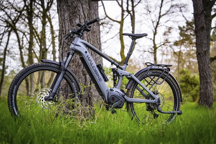Framed Print : An e-bike leaning against a tree in a spring-like forest