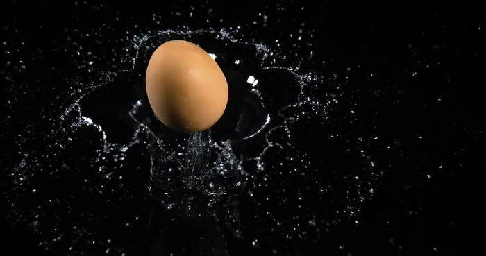 Framed Print : Egg Falling on Water against Black Background Framed Print : Egg Falling on Water against Black Background
