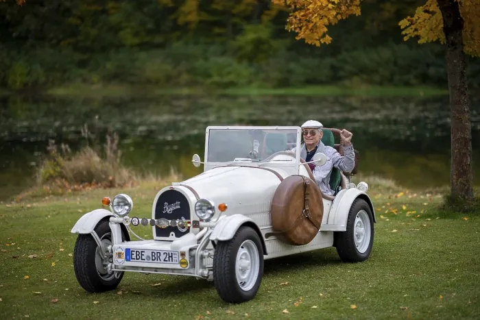 Framed Print : An elderly gentleman sitting in his replica of a 1923 Bugatti 35 B