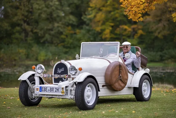 Framed Print : An elderly gentleman sitting in his replica of a 1923 Bugatti 35 B