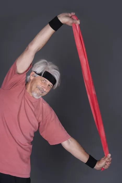 Framed Print : Elderly man with fitness outfit trains with fitness band
