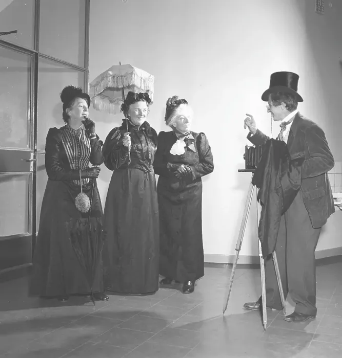 Framed Print : Three elderly women dressed in dresses from the turn of the century pose in front of a photographer with a camera Framed Print : Three elderly women dressed in dresses from the turn of the century pose in front of a photographer with a camera