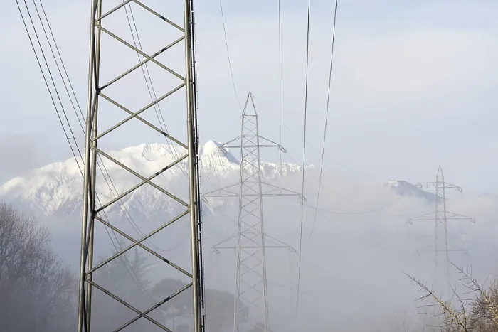 Framed Print : Electricity pylon with snow-capped mountain in Switzerland
