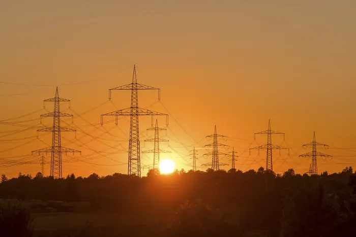 Framed Print : Electricity pylons in front of a glowing sunset on the horizon Framed Print : Electricity pylons in front of a glowing sunset on the horizon
