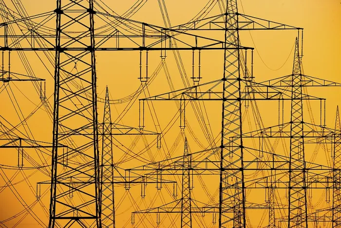 Framed Print : Electricity pylons of a power line at sunset