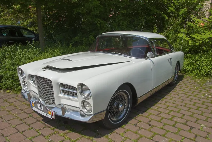 Framed Print : Elegant white classic car, shining in the sunlight on a paved square